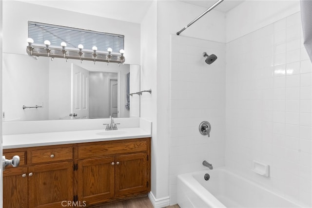 bathroom with tiled shower / bath, vanity, and hardwood / wood-style floors