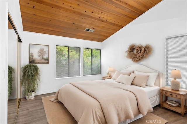 bedroom with wood-type flooring, wooden ceiling, and vaulted ceiling