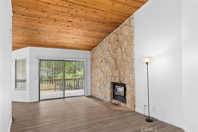 unfurnished living room with lofted ceiling, hardwood / wood-style floors, a wood stove, and wooden ceiling