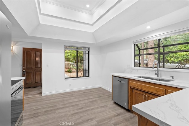 kitchen with dishwasher, light wood-type flooring, sink, and a wealth of natural light