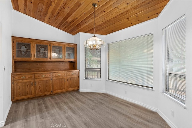 unfurnished dining area with light wood-type flooring, plenty of natural light, and lofted ceiling