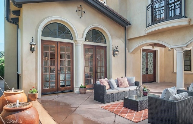 view of patio featuring french doors and a balcony