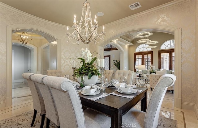 tiled dining area featuring crown molding and french doors