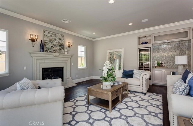 living room featuring light wood-type flooring and ornamental molding