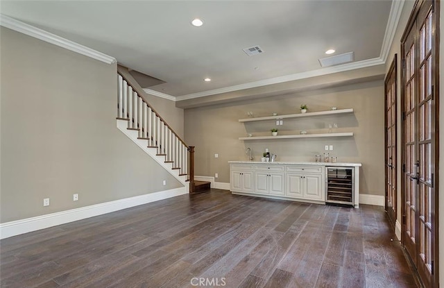 bar featuring dark wood-type flooring, white cabinets, sink, crown molding, and wine cooler