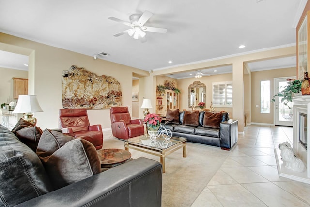 living room featuring ceiling fan, light tile patterned floors, and crown molding