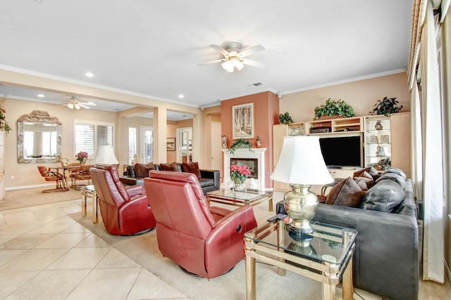 living room with ceiling fan, light tile patterned floors, and crown molding