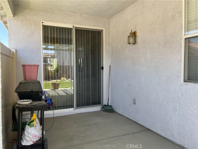 doorway to property with a patio area