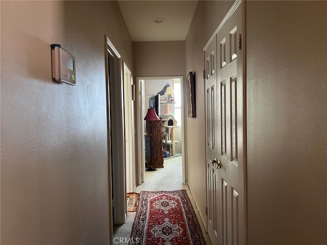 hallway featuring light carpet