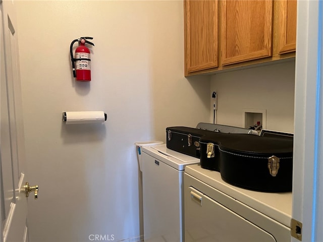 washroom featuring cabinets and washer and dryer