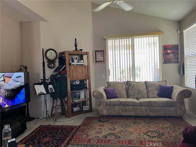 carpeted living room with vaulted ceiling and ceiling fan