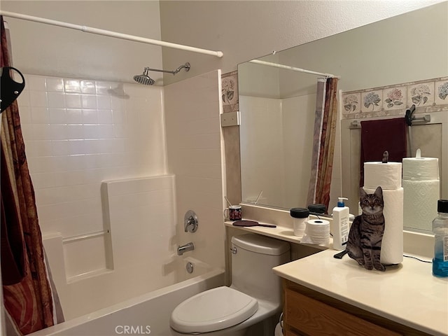 full bathroom featuring vanity, shower / bath combo with shower curtain, and toilet