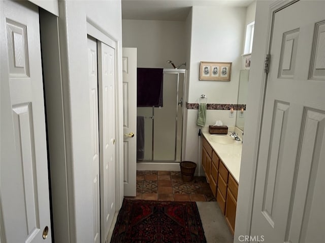 bathroom featuring vanity, tile patterned floors, and a shower with shower door