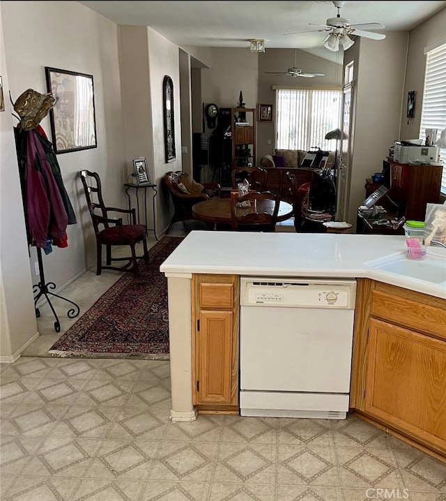 kitchen featuring lofted ceiling, dishwasher, ceiling fan, and sink