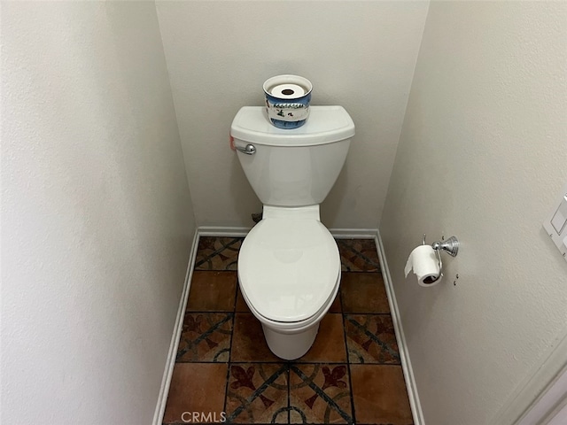 bathroom featuring toilet and tile patterned floors