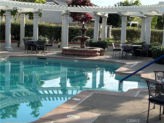 view of swimming pool featuring a patio and a pergola