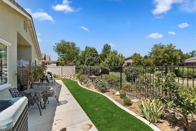 view of yard with a fenced backyard, cooling unit, and a patio