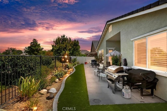 view of patio / terrace featuring a fenced backyard and a grill