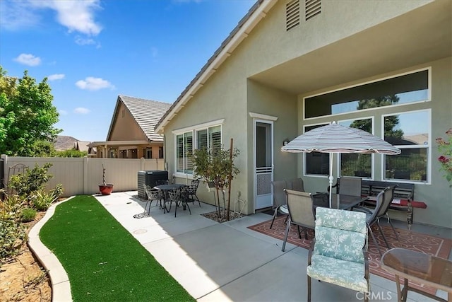 view of patio with fence and outdoor dining area