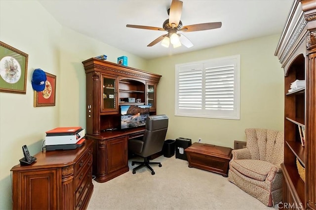 office with light carpet and ceiling fan