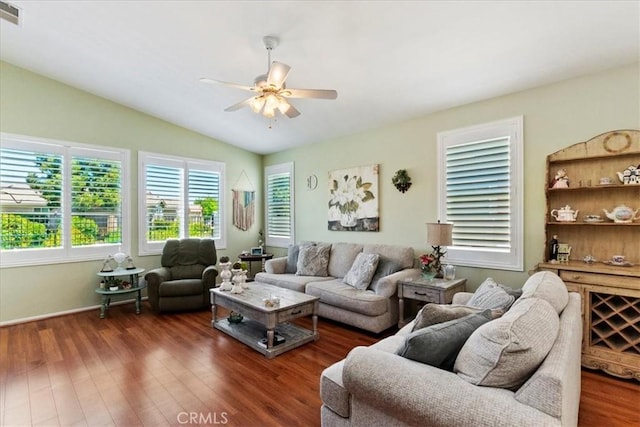 living area with vaulted ceiling, visible vents, wood finished floors, and a ceiling fan