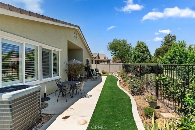 view of yard featuring central AC, a patio, and a fenced backyard