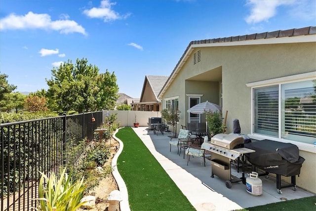 exterior space with a grill and a fenced backyard