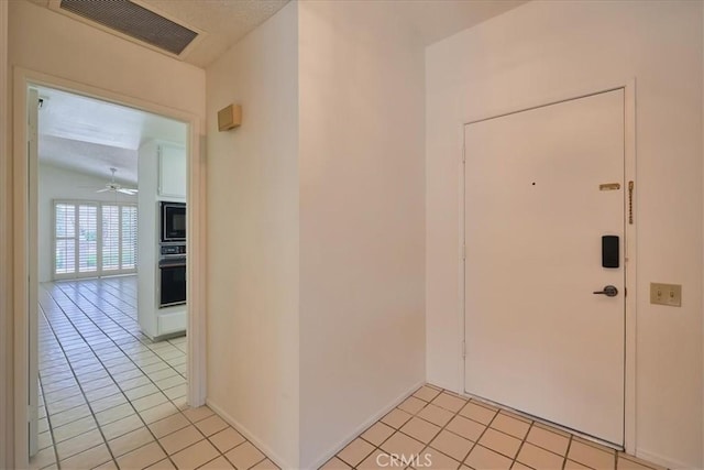 tiled entryway with ceiling fan