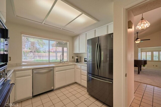 kitchen featuring sink, light tile patterned floors, ceiling fan, stainless steel appliances, and white cabinets