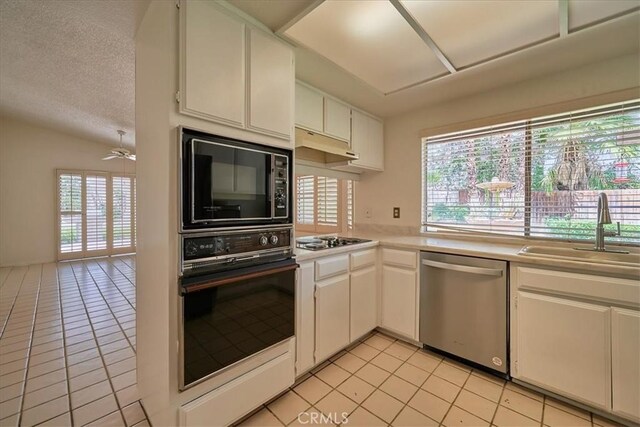 kitchen with white cabinetry, light tile patterned floors, sink, and black appliances