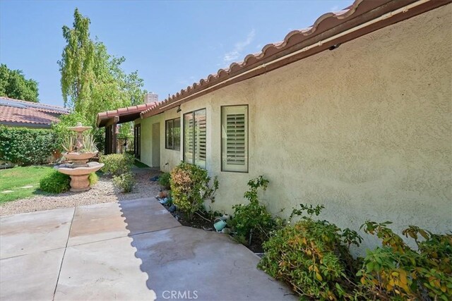 view of property exterior with a patio