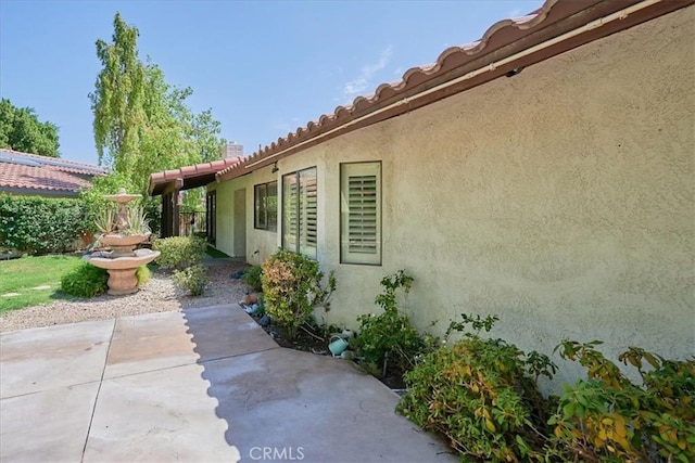 view of property exterior featuring a patio area