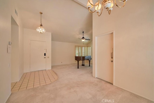 carpeted entryway featuring ceiling fan with notable chandelier