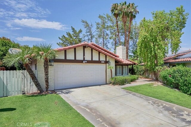 ranch-style house featuring a front lawn and a garage