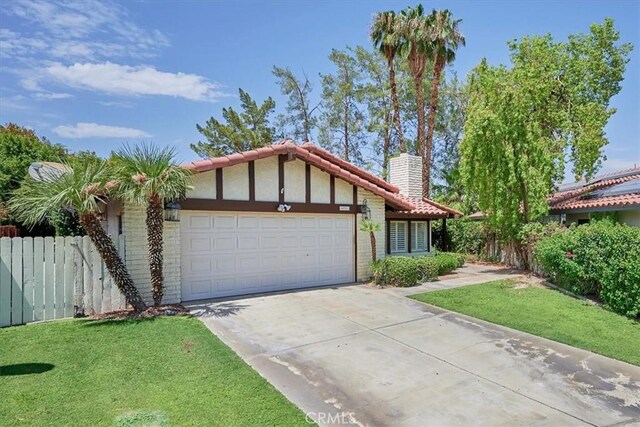 ranch-style home featuring a garage and a front lawn