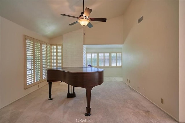 miscellaneous room with vaulted ceiling, ceiling fan, and light colored carpet