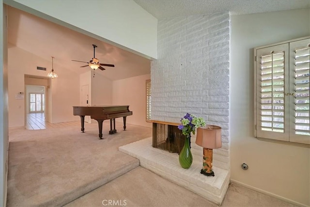 sitting room with carpet floors, high vaulted ceiling, and ceiling fan