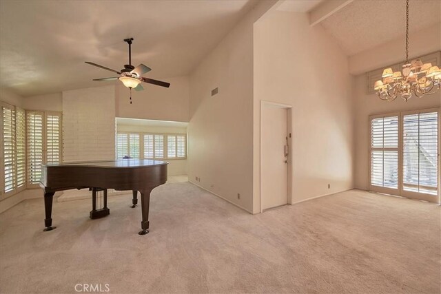 playroom with carpet, ceiling fan with notable chandelier, high vaulted ceiling, and beamed ceiling