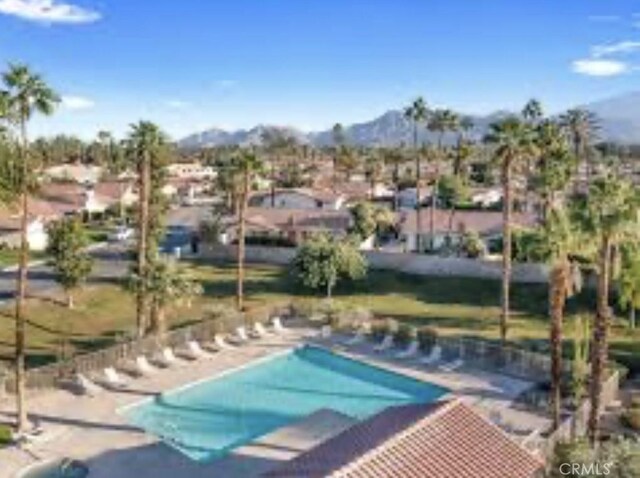 view of swimming pool with a mountain view and a patio