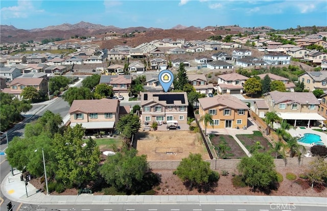 birds eye view of property with a mountain view