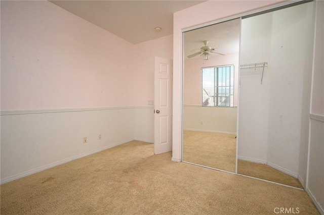 unfurnished bedroom with light colored carpet and a closet