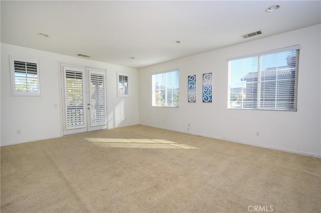 carpeted empty room with french doors