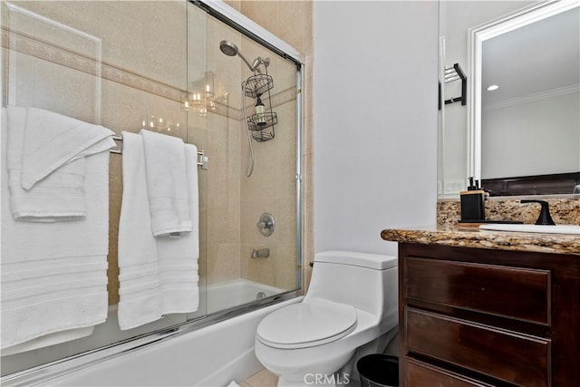 full bathroom featuring vanity, ornamental molding, toilet, and combined bath / shower with glass door