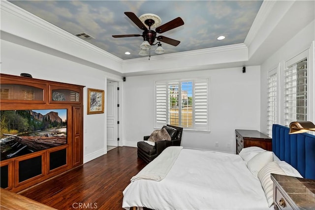 bedroom featuring a raised ceiling, crown molding, dark hardwood / wood-style floors, and ceiling fan