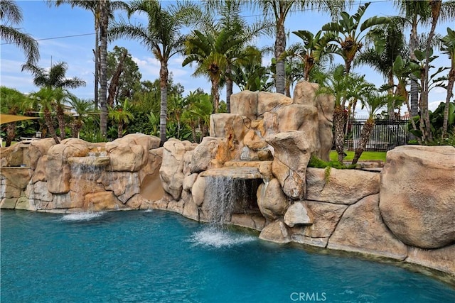 view of pool with pool water feature