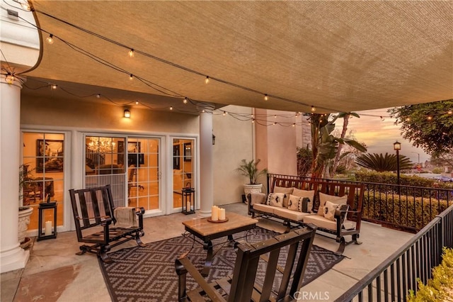 patio terrace at dusk featuring outdoor lounge area