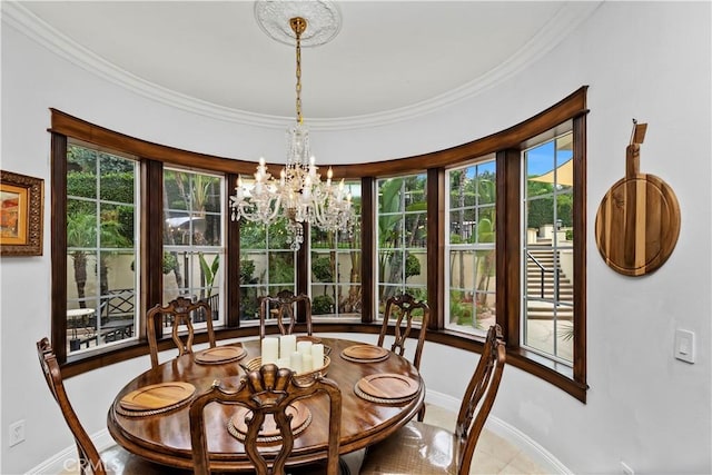 dining space featuring an inviting chandelier, plenty of natural light, and ornamental molding