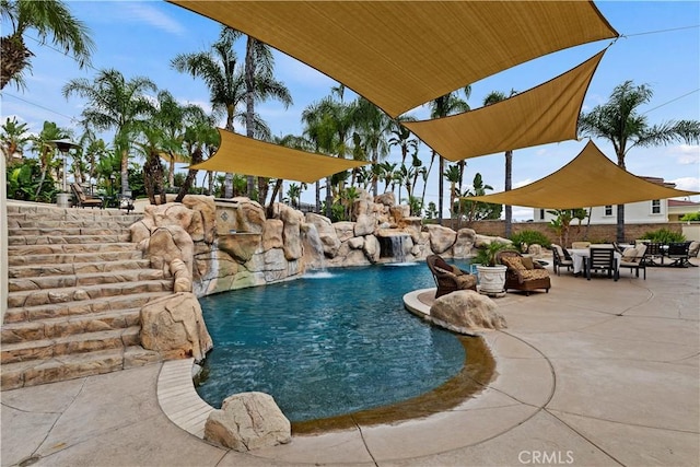 view of pool with a patio area and pool water feature