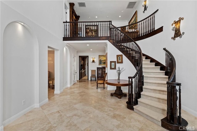 foyer entrance featuring a towering ceiling