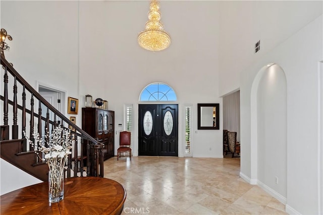 entryway featuring a towering ceiling